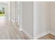 Hallway with stylish flooring and ample natural light throughout the home at 3448 Yellow Leaf Cir, Spring Hill, FL 34609