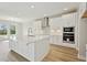 Bright, modern kitchen with white cabinets, stainless steel appliances, and a large center island at 3448 Yellow Leaf Cir, Spring Hill, FL 34609