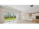 Open concept living room with sliding glass doors leading to the backyard and adjacent kitchen at 3448 Yellow Leaf Cir, Spring Hill, FL 34609