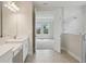 Bathroom featuring a walk-in shower, and access to the bedroom with natural light at 3458 Yellow Leaf Cir, Spring Hill, FL 34609