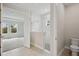 Bathroom featuring a walk-in shower, toilet, and access to the bedroom with natural light at 3458 Yellow Leaf Cir, Spring Hill, FL 34609