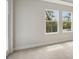 Bright bedroom featuring neutral carpet, neutral paint, and two windows with natural light at 3458 Yellow Leaf Cir, Spring Hill, FL 34609