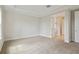 A bedroom featuring neutral carpeting, white trim, and an attached bathroom at 3458 Yellow Leaf Cir, Spring Hill, FL 34609