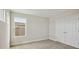 Bedroom featuring neutral carpet, trim, and a double-door closet at 3458 Yellow Leaf Cir, Spring Hill, FL 34609