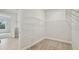 Walk-in closet with wire shelving, carpet, and access to the bedroom with natural light at 3458 Yellow Leaf Cir, Spring Hill, FL 34609