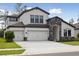 Beautiful two-story home featuring a three car garage and stone archway over the entryway at 3458 Yellow Leaf Cir, Spring Hill, FL 34609