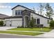 This home has a stone-accented entryway, a three-car garage, and a well-maintained front lawn at 3458 Yellow Leaf Cir, Spring Hill, FL 34609