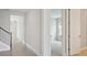 Hallway with wood floors, neutral paint, and doors to bedrooms and bathrooms at 3458 Yellow Leaf Cir, Spring Hill, FL 34609