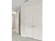 Hallway featuring neutral carpet, trim, and white doors at 3458 Yellow Leaf Cir, Spring Hill, FL 34609