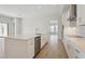 Bright, spacious kitchen featuring stainless steel appliances, white cabinets, and a large island with seating at 3458 Yellow Leaf Cir, Spring Hill, FL 34609