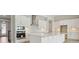 Bright kitchen featuring all-white cabinets, stainless steel appliances, and backsplash at 3458 Yellow Leaf Cir, Spring Hill, FL 34609