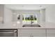 Bright kitchen featuring stainless steel appliances, white cabinets, and a large island with a sink at 3458 Yellow Leaf Cir, Spring Hill, FL 34609