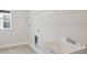 The laundry room has tile flooring, a utility sink, and overhead wire shelving at 3458 Yellow Leaf Cir, Spring Hill, FL 34609