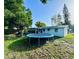 Spacious backyard with a trampoline, partial fence, and green grass at 3542 Monticello St, New Port Richey, FL 34652