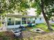 View of the backyard including a sunroom, chairs and a fire pit at 3542 Monticello St, New Port Richey, FL 34652