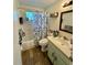 Functional bathroom with a tub and shower, vanity, and natural light at 3542 Monticello St, New Port Richey, FL 34652