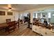 Open-concept dining room with hardwood floors and a view into the living room and kitchen at 3542 Monticello St, New Port Richey, FL 34652