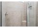Close up of the glass shower with white tiled walls, and a corner seat inside a bathroom at 3762 Mossy Limb Ct, Palmetto, FL 34221