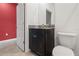 Well-lit half bathroom features a black vanity with a granite top, and a toilet at 3762 Mossy Limb Ct, Palmetto, FL 34221