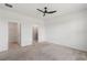 Neutral primary bedroom with carpet, ceiling fan, walk-in closet, and ensuite bathroom at 3762 Mossy Limb Ct, Palmetto, FL 34221