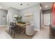 Modern dining room featuring a wood table, stylish chairs, contemporary lighting, and neutral decor for elegant dining at 3762 Mossy Limb Ct, Palmetto, FL 34221