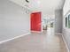 Open-concept living room with tile flooring, modern lighting, and a pop of color, leading to the kitchen and backyard at 3762 Mossy Limb Ct, Palmetto, FL 34221