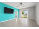 Open living space with tile flooring, a ceiling fan and a sliding glass door to the backyard at 3762 Mossy Limb Ct, Palmetto, FL 34221