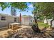 Inviting backyard showcasing mature trees, patio table, and detached shed at 4922 Bola St, New Port Richey, FL 34652