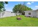 Spacious backyard with mature trees, a cozy fire pit, and a newly installed AC unit at 4922 Bola St, New Port Richey, FL 34652