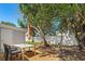 This is a shady backyard featuring a patio, a table set, and a privacy fence at 4922 Bola St, New Port Richey, FL 34652