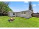 A spacious backyard features a fire pit and newly installed AC unit, offering outdoor entertainment at 4922 Bola St, New Port Richey, FL 34652