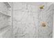 Modern bathroom featuring a tiled shower with a gold shower head and built-in niche shelving at 4922 Bola St, New Port Richey, FL 34652