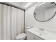 Clean bathroom with a shower curtain, toilet, sink, and vanity with modern fixtures and great lighting at 4922 Bola St, New Port Richey, FL 34652