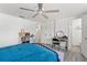 Bright bedroom with a ceiling fan, walk in closet and a view to the ensuite bathroom at 4922 Bola St, New Port Richey, FL 34652