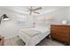 Bright bedroom showcasing a bed, dresser, large windows, and neutral color scheme for a serene feel at 4922 Bola St, New Port Richey, FL 34652