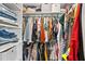 Organized walk-in closet filled with a variety of clothing, providing ample storage space at 4922 Bola St, New Port Richey, FL 34652