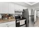 Kitchen featuring stainless steel appliances and white cabinetry at 4922 Bola St, New Port Richey, FL 34652