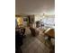 Bright living room featuring tile flooring, ceiling fan, and plenty of natural light at 5247 81St N St # 2, St Petersburg, FL 33709
