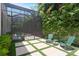 A screened outdoor pool is complemented by patio seating and lush greenery for a private backyard oasis at 534 Ladrone Ave, Tampa, FL 33606
