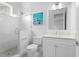 Bright bathroom featuring a glass shower, tiled floors, and white cabinets at 534 Ladrone Ave, Tampa, FL 33606