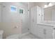 Stylish bathroom with a glass shower, white tile, and a modern vanity at 534 Ladrone Ave, Tampa, FL 33606