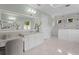Airy bathroom featuring a white vanity with marble counters, a glass shower, and lots of natural light at 534 Ladrone Ave, Tampa, FL 33606