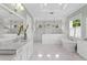 Spacious bathroom with marble floors, double vanity, soaking tub, and glass shower featuring multiple shower heads at 534 Ladrone Ave, Tampa, FL 33606