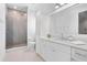 Modern bathroom featuring a glass shower, white cabinets, and a marble countertop at 534 Ladrone Ave, Tampa, FL 33606