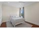 Calm bedroom featuring hardwood floors, white trim, and a cozy window at 534 Ladrone Ave, Tampa, FL 33606
