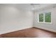 Bright room with hardwood floors, a ceiling fan, large window, and white trim at 534 Ladrone Ave, Tampa, FL 33606