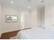 Light-filled bedroom with neutral color palette, hardwood floors, and an ensuite bathroom at 534 Ladrone Ave, Tampa, FL 33606