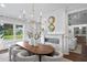 Dining room with fireplace, view of living room, elegant chandelier, and seating for eight at 534 Ladrone Ave, Tampa, FL 33606