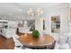 Open dining room with hardwood floors connecting to gourmet kitchen and living room with a stylish chandelier at 534 Ladrone Ave, Tampa, FL 33606