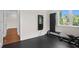 Bright home gym featuring workout equipment, rubber flooring, and natural light from a nearby window at 534 Ladrone Ave, Tampa, FL 33606